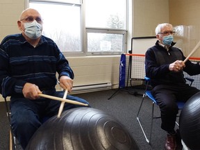 Henry Fountain (left) participates in a drum circle/exercise session, just one of the recreation programs known as “The Social” that the Alzheimer Society provides through donor support. - Photo supplied by the Alzheimer Society