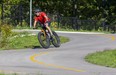A cyclist leans into a curve while cruising on the Thames Valley Parkway at Ross Park in London on Sept. 19, 2021.  An extension of the parkway in the SoHo neighbourhood is one of seven proposed upgrades for which the city is expected to seek funding from the federal and provincial governments.  (Derek Ruttan/The London Free Press)