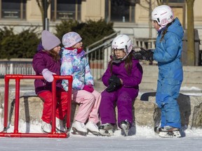 L to R Charlotte Westbrook, 6, Amelia Westbrook, 8, and seven-year-old twins Emmy Plastino and Audrey Plastino take a break for a chat while skating at the Rotary Rink at Covent Garden Market  London on Sunday January 16, 2022. Derek Ruttan/The London Free Press/Postmedia Network