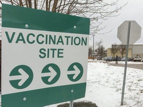 A sign points to the entrance of the Earl Nichols arena parking lot in London where the Middlesex-London Health Unit has reopened a mass vaccination clinic to help meet the increased demand for vaccines and booster shots. About 800 doses a day are being administered at the site. Photo taken Thursday, Jan. 6, 2022. (Mike Hensen/The London Free Press)