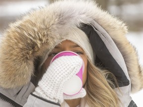 Teuta Lumani sips from a cup of warm coffee as she walks through a very cold Gibbons Park on Thursday January 20, 2022. Mike Hensen/The London Free Press