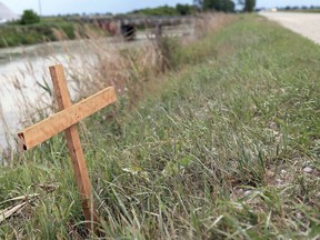 A homemade cross is erected near the scene of a deadly crash on July 27, 2020, on Jacob Road west of Pain Court that killed a young girl and injured two children. Ben Leveille, 36, the drunk driver responsible for the crash, was sentenced Tuesday to three years in prison. (Mark Malone/Postmedia Network)
