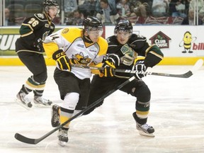 Reid Boucher, left, is shown playing for the Sarnia Sting during an OHL preseason game against the Knights in London on Friday, Aug. 31, 2012. The Sting removed him from the team's record books after he pleaded guilty in a Michigan court in December 2021 to sexually assaulting a 12-year-old girl while billeting with her family in 2011. (Postmedia Network file photo)