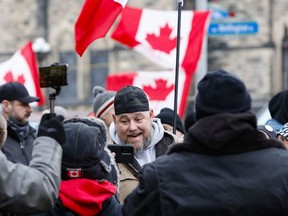 One of the protest leaders, Pat King, appears among the flag-waving crowd in downtown Ottawa on Wednesday.