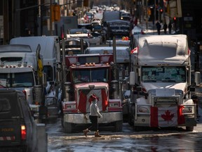 Vehicles block a road during a protest by truck drivers over pandemic health rules and the Trudeau government, outside the parliament of Canada in Ottawa on February 15, 2022. (Photo by Ed JONES / AFP)