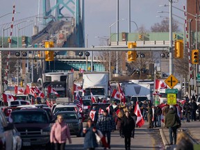 Protestors against Covid-19 vaccine mandates block the roadway at the Ambassador Bridge border crossing in Windsor, Ontario, Canada, on  February 9, 2022. (Photo by Geoff Robins / AFP)