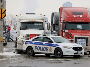 Vehicles block the Sir John A. McDonald Parkway, west of Parliament Hill as truckers and their supporters continue to protest against COVID-19 vaccine mandates, in Ottawa, Ontario, Canada, Feb. 8, 2022.
