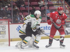 London Knights blue-liner Ethan MacKinnon jostles with Soo Greyhounds player Tye Kartye immediately in front of goalie Brett Brochu during their OHL game in Sault Ste. Marie on Saturday Feb. 26, 2022. Brochu delivered a shutout, winning 3-0. Gordon Anderson/Sault Star