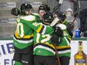 Colton Smith is congratulated by London Knight teammates Landon Sim (90), Tye McSorley (12) and Gerard Keane (45) after his first period goal against the Windsor Spitfires at Budweiser Gardens.  (Derek Ruttan/The London Free Press)