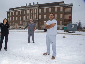 London's emergency doctors, including Julie Kim, left, Bill McCauley and Amit Shah, are giving $100,000 to Indwell, a charity creating 130 affordable housing units on the site of the former South Street hospital in London. McCauley said the donation honours the legacy of emergency work at the site and will help a population often treated by emergency physicians. (Derek Ruttan/The London Free Press)
