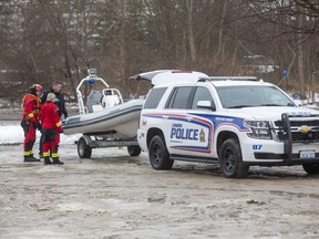Police and firefighters, seen here at Wonderland Road and Riverside Road, have ended their search of the Thames River for a missing man. (Derek Ruttan/The London Free Press)