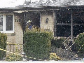 A fire investigator stands in the front door of a home at 1281 Hillcrest Ave. in London that was damaged by a fire Feb. 1. A spokesperson for the City of London said it won't share information about the results of a city investigation into the fire at the home where 15 tenants were living. Photograph taken Feb. 3, 2022. 
(Mike Hensen/The London Free Press)