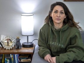 Brandy Robertson, 39, seen here wearing her late father, Neil Reece's Canadian Army hoodie, has seen  COVID-19's impact on London hospitals first-hand: the pandemic delayed Reece's surgery three times last year. Sadly, weakened by a five-year wait for a transplant, he died 113 days after the procedure. (Mike Hensen/The London Free Press)