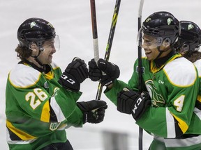 London Knights defenseman Isaiah George (#4) celebrates his goal  against the Kitchener Rangers during an afternoon game at Budweiser Gardens on Family Day in London. Cameron Baber, left, congratulates him. Photograph taken on Monday February 21, 2022. (Mike Hensen/The London Free Press)