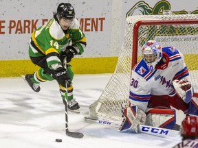 London Knights captain Luke Evangelista reaches for a rebound at the side of the net in front of Kitchener Rangers goalie Pavel Cajan in the first period at Budweiser Gardens in London on Family Day. Evangelista was held without a point for just the fifth time this season as the Knights lost 5-4 in overtime. (Mike Hensen/The London Free Press)