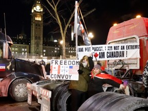 Supporters of a trucker convoy to protest COVID vaccine mandates for cross-border truck drivers pose for a photo on Parliament Hill in Ottawa, Ontario, Canada, on Friday, Jan. 28, 2022.