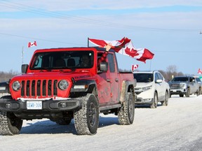 A convoy protesting COVID-19 mandates leaves a truck stop and heads toward Hwy. 402 on Sunday, Feb. 6, 2022 in Plympton-Wyoming, Ont. Terry Bridge/Sarnia Observer