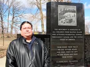 Sean Hoogterp, the new Indigenous initiatives co-ordinator at Brescia, Huron and King's university colleges in London, stands at the residential school monument on Walpole Island First Nation. (Ellwood Shreve/Postmedia Network)