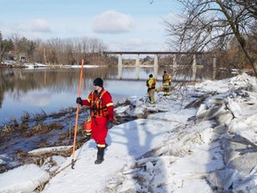 Volunteer firefighters Greg St. Clair and Shawn McNaughton, with St. Marys Fire Chief Richard Anderson, walk the bank of the Thames River on Thursday, five days into the search for a missing 10-year-old girl who feel through ice on Whirl Creek in Mitchell. Chris Montanini\Stratford Beacon Herald