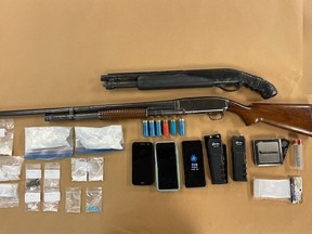 A London man and woman face several charges after officers seized two shotguns, two stun guns and drugs valued at more than $22,000 from a residence on Proudfoot Lane. (London police photo)