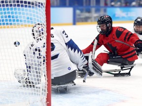 Tyler McGregor of Forest scores against Jae Woong of South Korea in the third period of a para ice hockey semifinal Friday at the Beijing Winter Paralympics. McGregor scored four goals in Canada's 11-0 win. (Ryan Pierse/Getty Images)