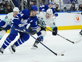 Toronto Maple Leafs forward Auston Matthews (34) carries the puck past Seattle Kraken forward Jared McCann (16) during the second period at Scotiabank Arena. (John E. Sokolowski-USA TODAY Sports)