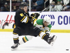 Sarnia Sting's Max Namestnikov (81) is knocked down by London Knights' Isaiah George (4) in the first period at Progressive Auto Sales Arena in Sarnia on Sunday, March 20, 2022. Mark Malone/Chatham Daily News/Postmedia Network