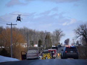 An OPP helicopter flies over the tributaries of Whirl Creek in the Southwestern Ontario town of Mitchell.  Emergency crews were scanning the water for a missing 10-year-old girl who fell through the ice on the creek.  (Calvi Leon/The London Free Press)