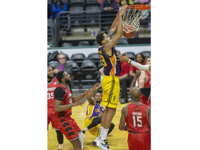 London Lightning player Amir Williams dunks during their game against the Windsor Express at Budweiser Gardens in London on Sunday March 27, 2022.  (Derek Ruttan/The London Free Press)