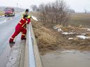 Firefighters scan Whirl Creek near Mitchell, Ont.  on Monday March 7, 2022. A 10-year-old girl fell through ice on the creek on Sunday morning, emergency officials say.  Derek Ruttan/The London Free Press/Postmedia Network