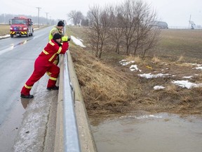 Firefighters scan Whirl Creek near Mitchell, Ont. on Monday March 7, 2022. A 10-year-old girl fell through ice on the creek on Sunday morning, emergency officials say. Derek Ruttan/The London Free Press/Postmedia Network