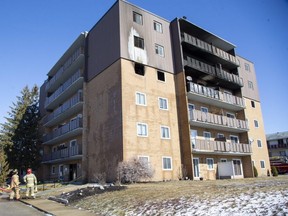 Firefighters used ladders to rescue several people from their balconies during a blaze 195 Lisgar Avenue  in Tillsonburg on Tuesday March 8, 2022. (Derek Ruttan/The London Free Press)