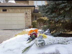 Flowers were placed outside a home at 455 Billybrook Cres on Sunday March 13, 2022. A 52-year-old man is charged with second-degree murder after emergency crews found a woman's body at the home on March 11. (Derek Ruttan/The London Free Press)