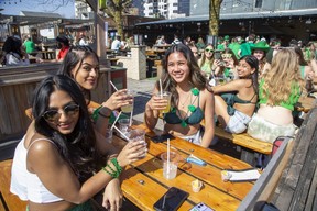 Western University students Mira Patel, left, Shreya Anand and Clarissa Loo celebrate St Patrick's Day on the terrace of Barney's in London. (Derek Ruttan/The London Free Press)