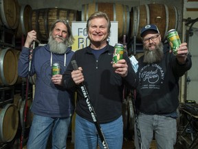 Dave Simpson, centre, teamed up with Forked River Brewing co-owners Andrew Peters and Dave Reed to create Simpson Blonde Ale in recognition of the 40th anniversary of Simpson's 155 point season with the London Knights. A portion of the sales from the brew will be donated to help the people of Ukraine. (Derek Ruttan/The London Free Press)