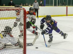 Finn McIntyre of the West London Hawks scores on North London Nationals goalie Jamie Moore in overtime to give his team a 1-0 U10 house league championship victory at Kinsmen Arena in London on Sunday March 27, 2022. (Derek Ruttan/The London Free Press)