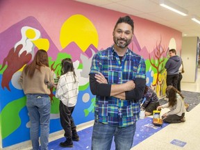 Artist Mike Cywink is guiding students at Sir Wilfrid Laurier secondary school in London who are creating a mural that reflects the school's diversity. (Derek Ruttan/The London Free Press)