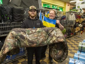 Forest City Surplus purchasing manager Cody VanDiepen, left, and marketing director Tim Hodges recently sold more than 2,000 sleeping bags to a U.S.-based charity that is giving them to Ukrainian soldiers fighting invading Russian forces. (Derek Ruttan/The London Free Press)