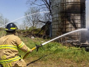 London firefighters battle a barn fire near Lambeth on Tuesday May 18, 2021. London politicians will vote soon on a staff recommendation to remove the historic farm at 3700 Colonel Talbot Rd. from the city's heritage list, clearing the way for it to be developed. (Mike Hensen/The London Free Press)