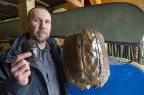 Scott Gillingwater, the species-at-risk biologist with the Upper Thames River Conservation Authority, holds a spotted turtle carapace at left and a large adult snapping turtle carapace at right.  Photo taken in London on Tuesday, March 1, 2022. (Mike Hensen/The London Free Press)