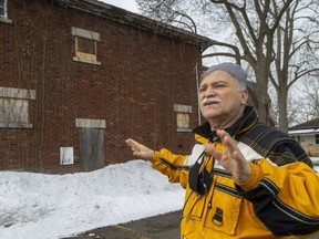 Spiros Letsos owns three boarded-up houses on Grey Street just south of downtown London. He has received a bill from city hall for window and door repairs he says he had already hired a handyman to fix. (Mike Hensen/The London Free Press)
