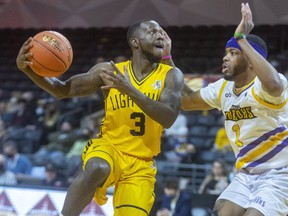 Chris Jones of the London Lightning throws up a hook shot over Jamyrin Jackson of the Lansing Pharaohs in inter-league pro basketball action at Budweiser Gardens in London on Sunday March 6, 2022. Mike Hensen/The London Free Press