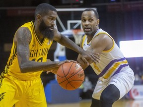 Terry Thomas of the Lightning drives around Maurice Benson of the Lansing Pharaohs in NBL action at Budweiser Gardens in London on Sunday March 6, 2022.  (Mike Hensen/The London Free Press)