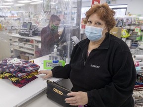 Donna Knight buys fabric at FabricLand on Wonderland Road in London on Wednesday March 9, 2022. Knight said she has made more than 600 masks during the pandemic, "but this is for crafts, cause masks are over."  (Mike Hensen/The London Free Press)