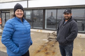 Karri Egan and Roberto Briceno stand outside 308 Wellington St. in St. Thomas where Boxcar Donuts plans to open its third store this summer. (Mike Hensen/The London Free Press)