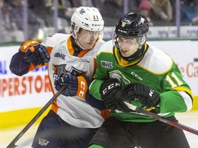 London Knights player Liam Gilmartin takes Coulson Pitre of the Flint Firebirds into the boards during a game in March. The Knights trade Gilmartin to the Erie Otters for draft picks. (Free Press file photo)