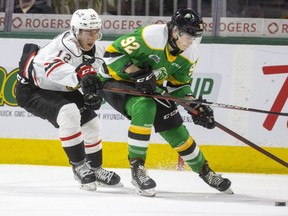 William Portokalis of the Owen Sound Attack back-checks Jackson Edward of the London Knights during the first period at Budweiser Gardens in London on Friday, March 25, 2022. The Knights won 7-3. (Mike Hensen/The London Free Press)
