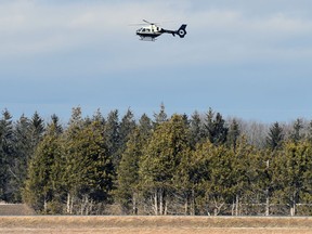 A low-flying helicopter is visible just east of Mitchell on the afternoon of Sunday March 6, 2022 as local fire departments search the tributaries of Whirl Creek after reports of a child falling through ice around 10:30 a.m. ANDY BADER/POSTMEDIA NETWORK