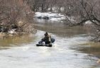 Members of an OPP search and recovery team patrol Whirl Creek east of Road 160 in Mitchell Wednesday for a missing 10-year-old girl who fell through the ice on Sunday.  (Andy Bader/Postmedia Network)