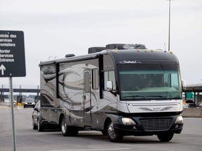 Recreational vehicles and cars of "snowbirds", a term for people who leave Canada before the snow falls and return in the spring, and other Canadians return at the U.S.-Canada border crossing in Lacolle, Quebec, Canada March 18, 2020.  (REUTERS/Christinne Muschi)